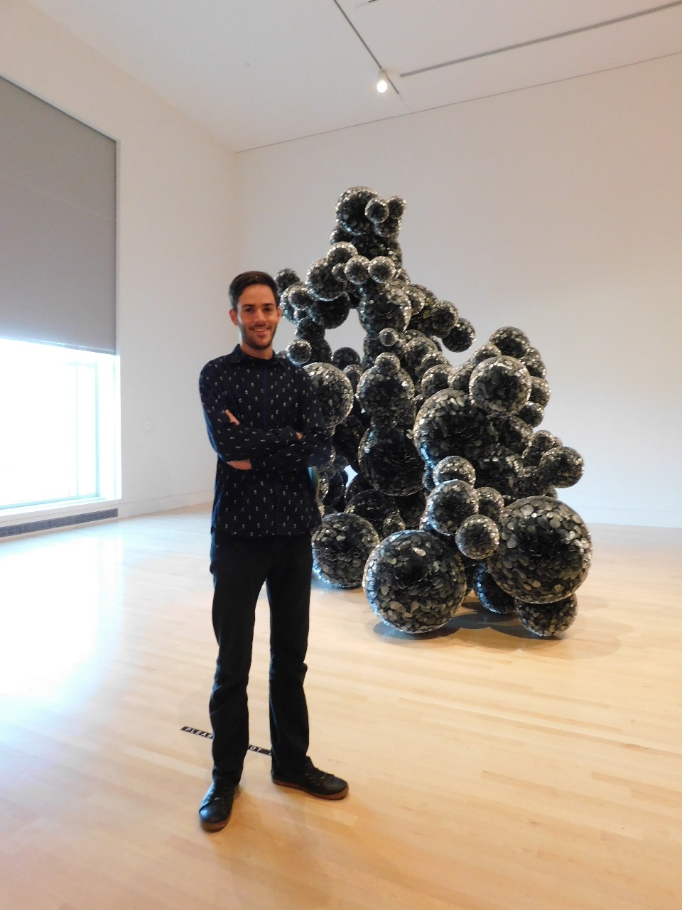 Student Tomás Lopez Cajaraville at the Indianapolis Museum of Art with the sculpture “Untitled (Mylar)” by Tara Donovan, which he describes as "one of the most fascinating contemporary sculptures I have ever seen."